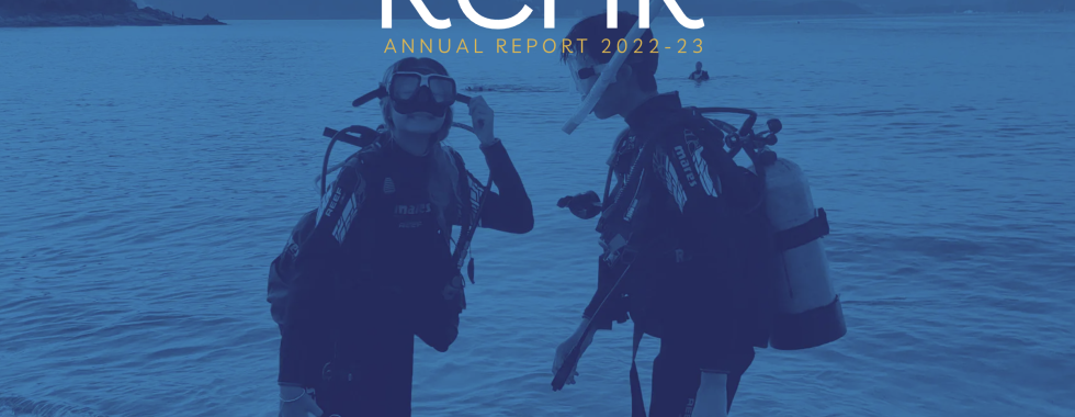 Blue filter cover with students on the beach - the cover of Annual Report 2022-23 of Renaissance College Hong Kong (RCHK)